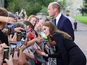 Catherine, Princess of Wales and Prince William, Prince of Wales speaks with members of the public on the Long walk at Windsor Castle on September 10, 2022 in Windsor, England.