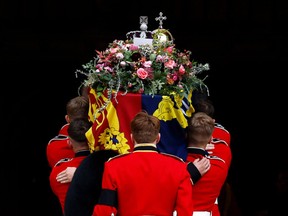 The Bearer Party take the coffin of Queen Elizabeth II, from the State Hearse, into St George's Chapel inside Windsor Castle on September 19, 2022, for the Committal Service for Britain's Queen Elizabeth II.