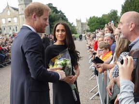 Prince Harry, Duke of Sussex and Meghan, Duchess of Sussex speak with members of the public at Windsor Castle on September 10, 2022 in Windsor, England.