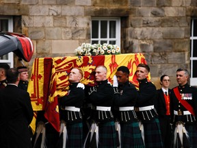 Pallbearers carry the coffin of Britain's Queen Elizabeth as they hearse arrives at the Palace of Holyroodhouse in Edinburgh, Scotland, Britain, September 11, 2022.