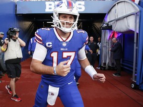 Buffalo Bills quarterback Josh Allen (17) runs toward the field before an NFL football game against the Tennessee Titans, Monday, Sept. 19, 2022, in Orchard Park, N.Y.