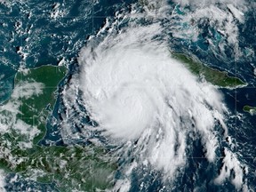 This National Oceanic and Atmospheric Administration (NOAA) satellite handout image shows tropical storm Ian over the Central Caribbean, on September 26, 2022 at 13:30 UTC.
