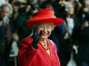 Queen Elizabeth II waves as she leaves the Royal York Hotel in Toronto Friday October 11, 2002. The Queen left for New Brunswick where she will continue her twelve-day Golden Jubilee tour of Canada.