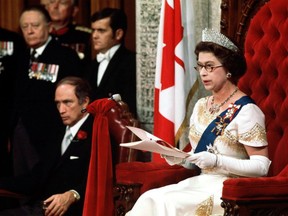 Queen Elizabeth II reads the Throne Speech in the Senate Chambers Oct. 18, 1977, officially opening the session of Parliament. Prime Minister Trudeau sits to the right of the Queen. (CP PHOTO)
