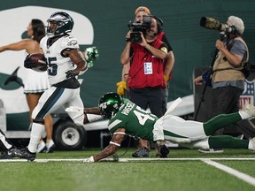 Philadelphia Eagles' Boston Scott, left, breaks away from New York Jets' J.T. Hassell during the first half of an NFL preseason football game, in East Rutherford, N.J., Friday, Aug. 27, 2021. Hassell will get into his first CFL game Saturday afternoon when Winnipeg (11-1) hosts the Saskatchewan Roughriders (6-6) in the sold-out Banjo Bowl at IG Field.