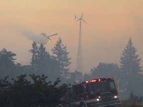 Firefighters use aircraft to battle a wildfire south of Salem, Ore., on Friday, Sept. 9, 2022. An air quality advisory has been issued for Metro Vancouver and the Fraser Valley due to high concentrations of fine particulate matter from wildfire smoke in the province and the United States.