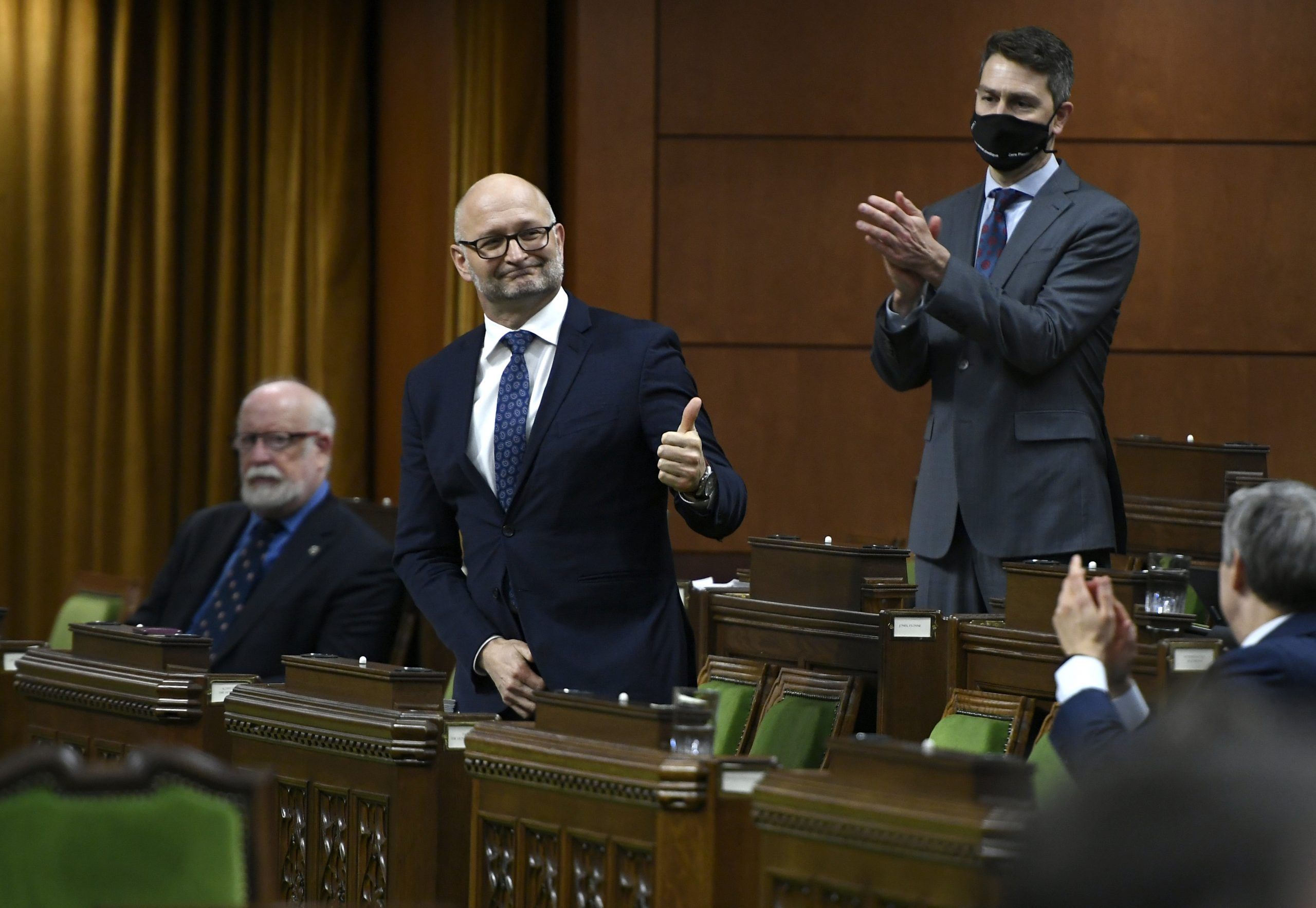 In this photo from late 2020, Minister of Justice David Lametti gives a thumbs up as he rises to vote in favour of a motion on Bill C-7, a bill which extended medically assisted death to Canadians without a terminal illness.
