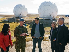 Prime Minister Justin Trudeau is briefed with NATO Secretary General Jens Stoltenberg, right, Defence Minister Anita Anand, far left, and Foreign Affairs Minister Mélanie Joly near radar domes of the North Warning System after arriving in the Arctic community of Cambridge Bay, Nunavut, on Aug. 25, 2022.