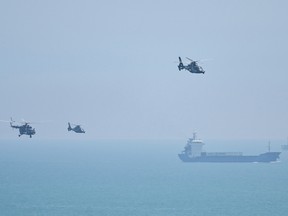 Chinese military helicopters fly past Pingtan island on August 4, 2022, one of China's closest points to Taiwan, ahead of massive military drills off the Taiwan coast following U.S. Speaker Nancy Pelosi's visit to the self-ruled island.