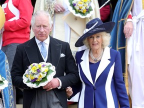 Prince Charles, Prince of Wales and Camilla, Duchess of Cornwall hold nosegays as they attend the Royal Maundy Service at St George's Chapel on April 14, 2022 in Windsor, England.