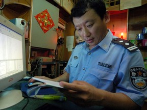 A police officer inspects an internet café in Fuzhou, China,
in a file photo from 2006. At least three operations in the Greater Toronto Area officially registered as Fuzhou Public Security Bureau “service stations” are actually illegal Chinese police stations, a new report alleges.