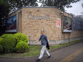 A man walks past Canada's embassy in Beijing.