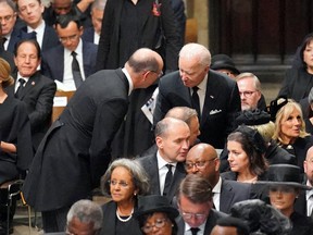 U.S. President Joe Biden takes his seat with wife Jill Biden, other heads of state, including French President Emmanuel Macron at the State Funeral of Queen Elizabeth II on September 19, 2022.