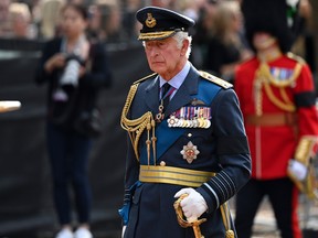 King Charles III walks behind the coffin during the procession for the lying in state of Queen Elizabeth II on September 14, 2022 in London, England.