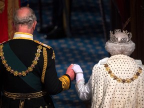 Queen Elizabeth II and Prince Charles attend the State Opening of Parliament in London on Oct. 14, 2019 in London, England. The Queen died Sept. 8, marking the beginning of the reign of King Charles III.