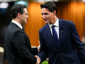 Newly elected Conservative Leader Pierre Poilievre, left, and Prime Minister Justin Trudeau greet each other as they gather in the House of Commons to pay tribute to Queen Elizabeth on Sept. 15, 2022.