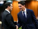 Newly elected Conservative Leader Pierre Poilievre, left, and Prime Minister Justin Trudeau greet each other as they gather in the House of Commons to pay tribute to Queen Elizabeth on Sept. 15, 2022. 