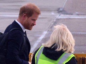 Prince Harry walks on the tarmac before boarding a plane as he travels to London following Thursday’s death of Queen Elizabeth II.