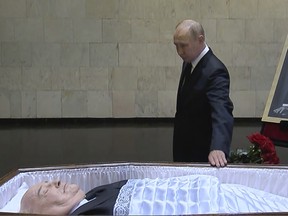 Russian President Vladimir Putin pays his last respects near the coffin of former Soviet President Mikhail Gorbachev at the Central Clinical Hospital in Moscow Russia on Thursday, Sept. 1, 2022.