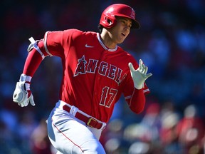 Los Angeles Angels designated hitter Shohei Ohtani (17) runs after hitting a double against the Seattle Mariners during the sixth inning at Angel Stadium.