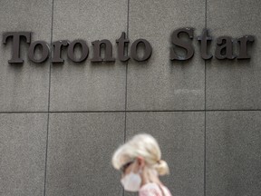 A woman walks past the Toronto Star head office at 1 Yonge Street.