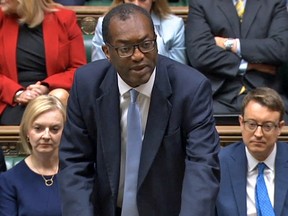 Britain's Chancellor of the Exchequer Kwasi Kwarteng, with new prime minister Liz Truss on the left, unveils an anti-inflation budget plan at the House of Commons in London on September 23, 2022.