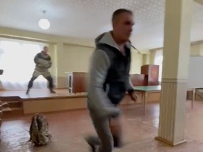 A gunman opens fire at a military draft office in Ust-Ilimsk, Irkutsk region, Russia September 26, 2022 in this screengrab obtained from social media video.