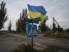 A Ukrainian flag waves on a street of the recently liberated village of Vysokopillya, Kherson region, in Ukraine on September 27, 2022.