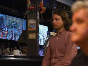 People watch the funeral of Queen Elizabeth on television screens at The Bishop and Belcher pub in Toronto on the morning of Monday, Sept. 19, 2022.&ampnbsp;Moments of silence and other tributes are set to be held for Queen Elizabeth II across Ontario this afternoon.