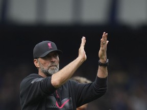 Liverpool's manager Jurgen Klopp walks on the pitch at the end of the English Premier League soccer match between Everton and Liverpool at Goodison Park, Liverpool, England, Saturday, Sept. 3, 2022.