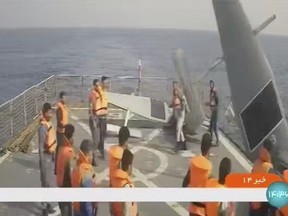In this frame grab from Iranian state television, Iranian navy sailors throw an American sea drone overboard in the Red Sea on Thursday, Sept. 1, 2022. Iran said Friday its navy seized two American sea drones in the Red Sea before letting them go, the latest maritime incident involving the U.S. Navy's new drone fleet in the Mideast. Cmdr. Timothy Hawkins, a spokesman for the Navy's Mideast-based 5th Fleet, acknowledged the incident on Friday to The Associated Press but declined to immediately elaborate.