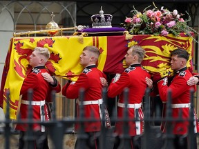 Pallbearers carry the coffin of Queen Elizabeth II, draped in the Royal Standard with the Imperial State Crown during her State Funeral at Westminster Abbey in London, Monday, Sept. 19, 2022. The Queen, who died aged 96 on Sept. 8, will be buried at Windsor alongside her late husband, Prince Philip, who died last year.