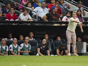 Canada's coach Bev Priestman, right, gives instructions during the CONCACAF Women's Championship final soccer match against United States in Monterrey, Mexico, Monday, July 18, 2022.