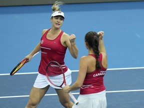 FILE PHOTO -- Canada's Gabriela Dabrowski (left) and Rebecca Marinov celebrate after defeating Alize Cornet and Clara Burrel of France in their group A Billie Jean King Cup finals tennis match in Prague, Czech Republic, Monday, Nov. 1, 2021. Dabrowski and Mexican partner Giuliana Olmos were bounced from the U.S. Open women's doubles play on Wednesday.