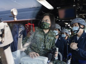 FILE - In this photo released by the Taiwan Presidential Office, Taiwan's President Tsai Ing-wen is seen through glass onboard a navy ship during inspection of Taiwan's annual Han Kuang exercises in Taiwan on Tuesday, July 26, 2022. Tsai said Tuesday, Sept. 6, 2022, that China is conducting "cognitive warfare" by spreading misinformation in addition to its regular incursions into nearby waters and airspace intended at intimidating the self-governing island.