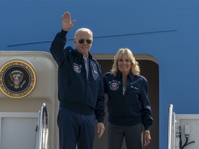 U.S. President Joe Biden waves as first lady Jill Biden watches standing at the top of the steps of Air Force One before boarding at Andrews Air Force Base, Md., Saturday, Sept. 17, 2022. President Biden said during and interview broadcasted on Sunday, Sept. 18, 2022, that U.S. forces would defend Taiwan if China tries to invade the self-ruled island claimed by Beijing as part of its territory, adding to displays of official American support for the island democracy in the face of Chinese intimidation.