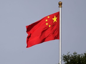 FILE - A Chinese national flag flies at Tiananmen Square in Beijing Thursday, June 14, 2018. A court in northern China sentenced one man to 24 years in jail Friday, Sept. 23, 2022, for his role in a vicious attack on four women, as well as other crimes including robbery and opening an illegal gambling ring.