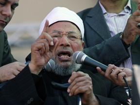FILE -Senior Egyptian cleric Sheik Youssef al-Qardawi speaks to the crowd as he leads Friday prayers in Tahrir Square in Cairo, Egypt, Feb. 18, 2011. Al-Qardawi, a cleric who was seen as the spiritual leader of the pan-Arab Muslim Brotherhood, has died at the age of 96.