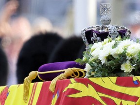 A crown is pictured during the procession of the coffin of Britain's Queen Elizabeth from Buckingham Palace to the Houses of Parliament for her lying in state, in London, Britain, Sept. 14, 2022.