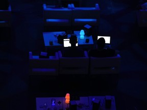 A man looks at his screen during a cryptocurrency event in Madrid, Spain, Saturday, Aug. 27, 2022. Senior federal bureaucrats examined whether cryptocurrencies protect against inflation not long after Opposition Leader Pierre Poilievre made the claim as a candidate in the Conservative leadership race, according to an internal government document.