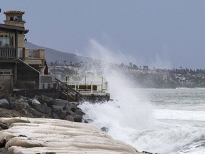 Waves crash into boulders in front of homes at Capistrano Beach in Dana Point, Calif., on Friday, Sept. 9, 2022. The remains of Tropical Storm Kay combined with the morning high tide brought the danger of further erosion to the area.