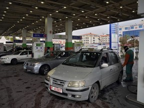 FILE - Drivers wait to get fuel at a gas station in the southern Beirut suburb of Dahiyeh, Lebanon, March 15, 2022. Lebanon's central bank lifted its remaining subsidies on fuel on Monday, Sept 12, 2022, gas station owners said, ending a year-long process of scaling back on the expensive program. Fuel subsidies once cost the cash-strapped country some $3 billion annually. Lebanon is in the throes of a crippling economic crisis that has plunged three-quarters of its population into poverty and decimated the value of the Lebanese pound against the dollar by around 90 percent.