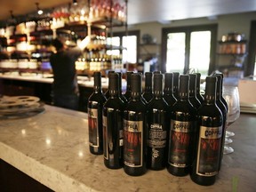 FILE - Bottles of Apocalypse Now Red Blend wine stand on a tasting bar counter at the Francis Ford Coppola Winery on May 21, 2020, in Geyserville, Calif. The California Legislature approved a measure Wednesday, Aug. 31, 2022, that would add wine and distilled spirits containers to the state's recycling program, sending it to Gov. Gavin Newsom.