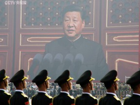 Soldiers of People's Liberation Army in front of a giant screen as Chinese President Xi Jinping speaks at the military parade marking the 70th founding anniversary of People's Republic of China on Oct. 1, 2019.