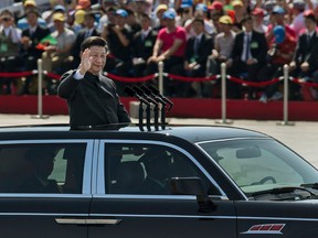A file photo of Chinese president and leader of the Communist Party Xi Jinping in front of Tiananmen Square and the Forbidden City.