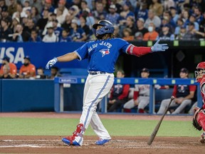 Toronto Blue Jays first baseman Vladimir Guerrero Jr. (27) watches the ball after hitting a two-run home run during third inning AL MLB baseball action against the Boston Red Sox, in Toronto on Friday, September 30, 2022.