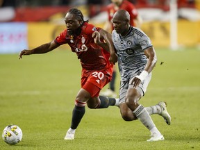 Toronto FC forward Ayo Akinola (20) and CF Montreal defender Rudy Camacho (4) run for the ball during first half MLS soccer action in Toronto on Sunday, Sept. 4, 2022.