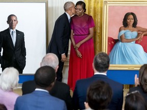 Former President Barack Obama kisses his wife former first lady Michelle Obama after they unveiled their official White House portraits during a ceremony in the East Room of the White House, Wednesday, Sept. 7, 2022, in Washington.