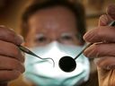 A patient's eye view, as a dentist poses for the photographer on April 19, 2006 in Great Bookham, England. 