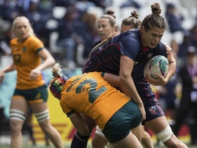 Ilona Maher of USA is tackled by Sharni Williams of Australia in a semi final match during the Rugby World Cup 7's championship held in Cape Town, South Africa, Sunday, Sept. 11, 2022.